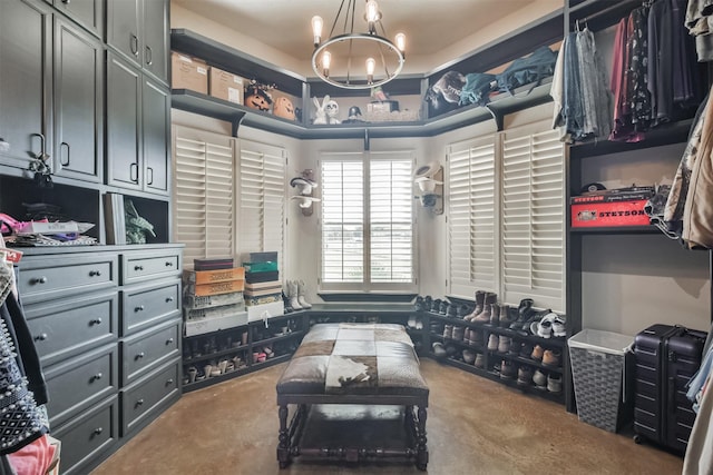 walk in closet featuring a chandelier