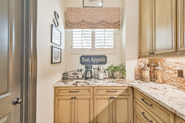 kitchen with light stone countertops, tasteful backsplash, and light brown cabinets