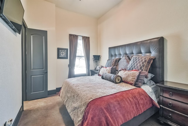 bedroom featuring lofted ceiling, light carpet, and baseboards