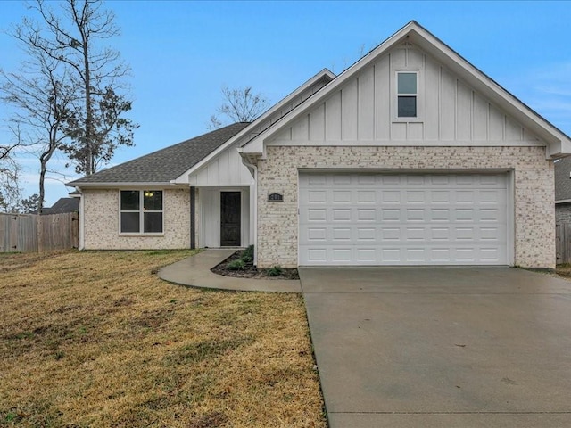 view of front of property featuring a garage and a front lawn