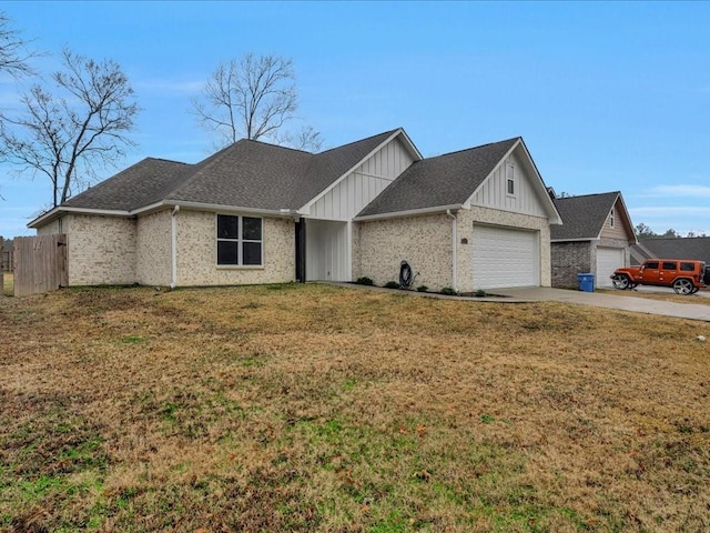 view of front of home with a garage and a front lawn