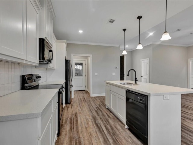 kitchen featuring pendant lighting, white cabinetry, an island with sink, sink, and black appliances