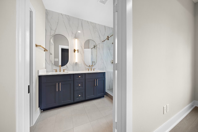 bathroom featuring vanity, tile patterned floors, tile walls, and a shower