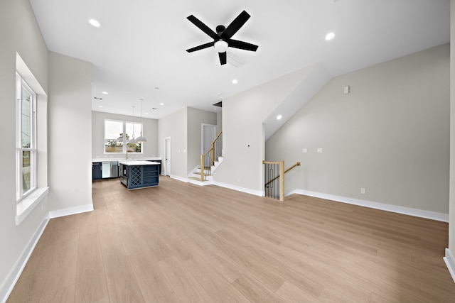 unfurnished living room featuring ceiling fan and light wood-type flooring