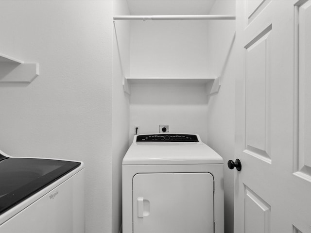 laundry area with washing machine and clothes dryer