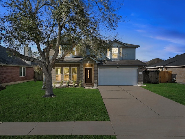 view of front of property featuring a garage and a lawn