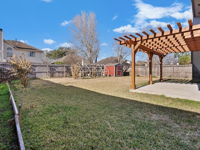 view of yard with a storage unit, a pergola, and a patio area