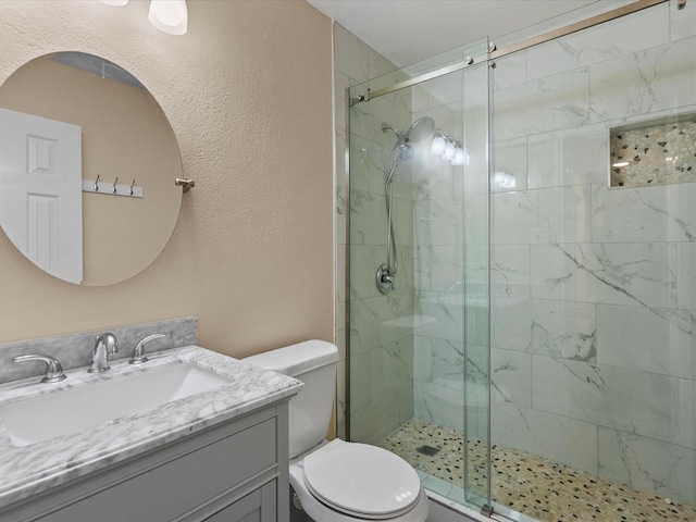 bathroom with vanity, an enclosed shower, and toilet