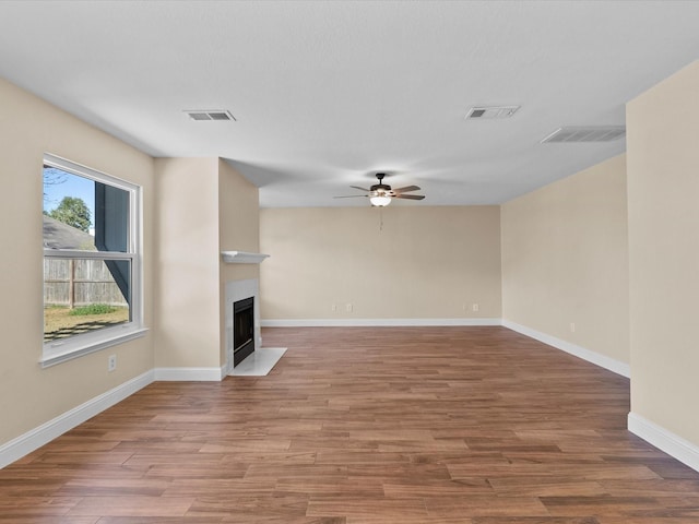 unfurnished living room with hardwood / wood-style flooring and ceiling fan