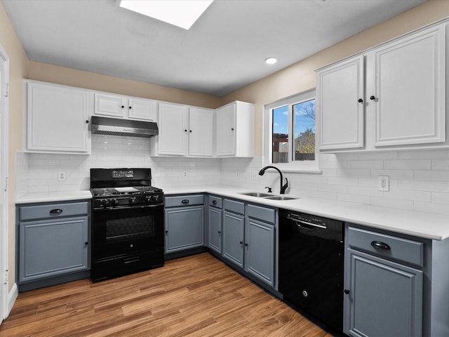 kitchen featuring gray cabinetry, white cabinets, sink, and black appliances