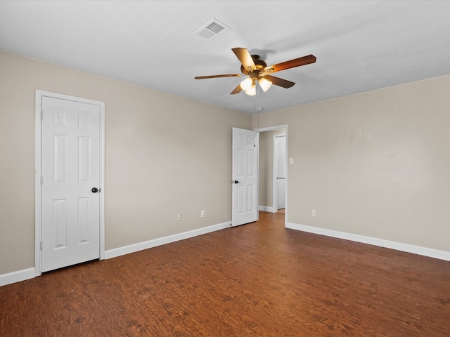 unfurnished room featuring ceiling fan and dark hardwood / wood-style flooring