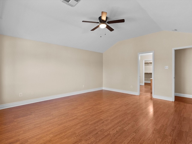 interior space with lofted ceiling, wood-type flooring, and ceiling fan