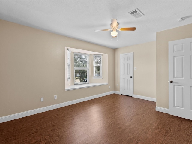 spare room featuring dark hardwood / wood-style floors and ceiling fan