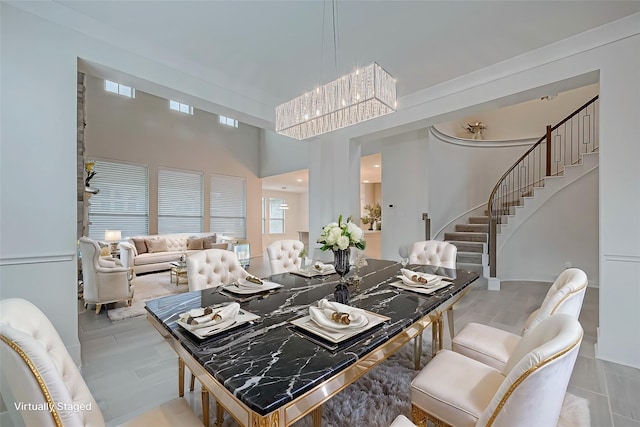 dining space with a towering ceiling