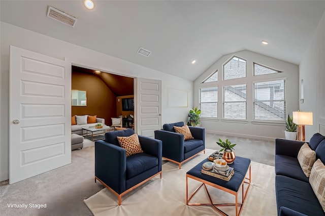 carpeted living room featuring vaulted ceiling