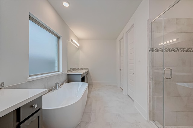 bathroom featuring vanity and separate shower and tub