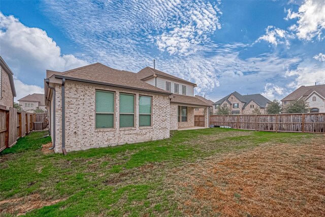 rear view of house with a lawn