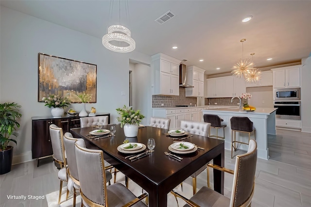 dining room featuring sink and an inviting chandelier