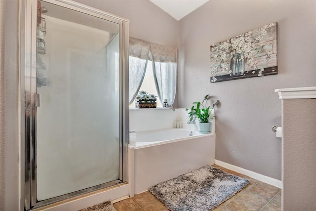 bathroom featuring plus walk in shower and tile patterned flooring