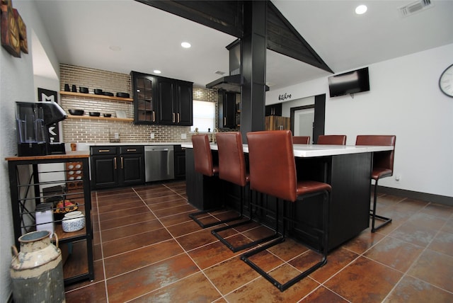 bar with dark tile patterned floors, tasteful backsplash, and stainless steel dishwasher