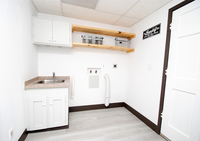 washroom with cabinets, hookup for an electric dryer, light hardwood / wood-style floors, and sink