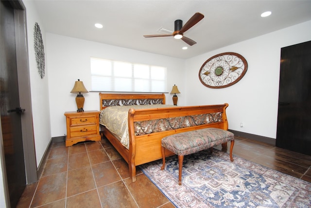 bedroom featuring ceiling fan and dark tile patterned flooring