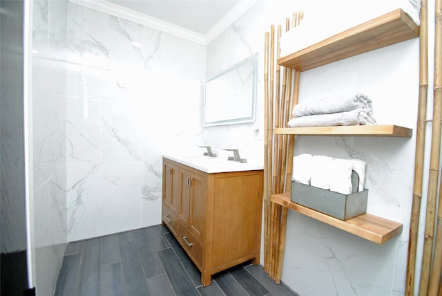 bathroom featuring vanity, crown molding, and tile walls