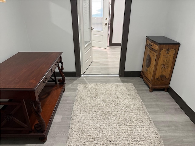 hallway with light hardwood / wood-style flooring