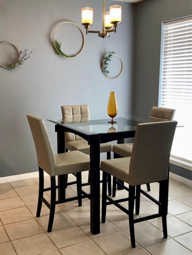 dining space featuring a wealth of natural light, an inviting chandelier, and light tile patterned floors