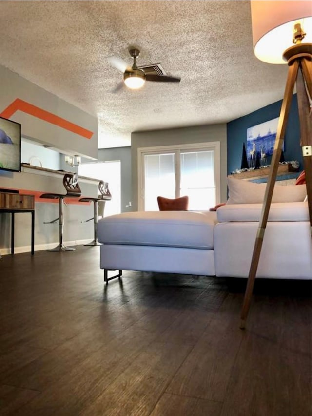 bedroom with dark hardwood / wood-style floors and a textured ceiling