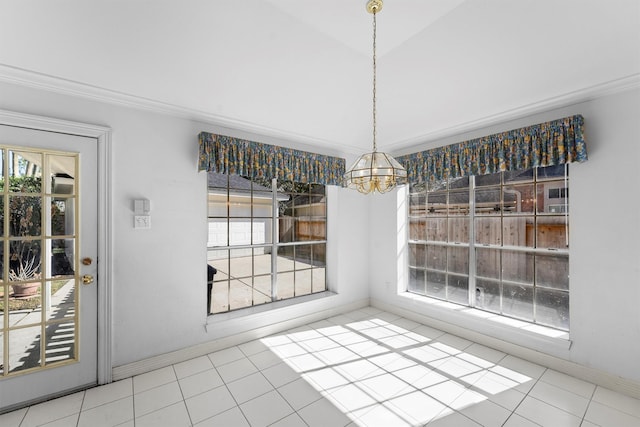 unfurnished dining area featuring a notable chandelier, ornamental molding, tile patterned flooring, and a wealth of natural light