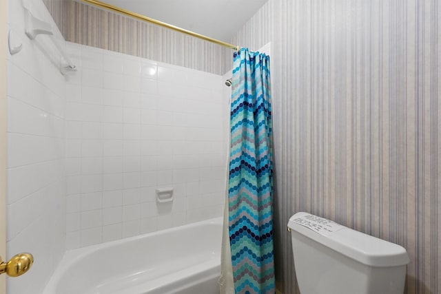 bathroom featuring shower / bath combination with curtain and toilet