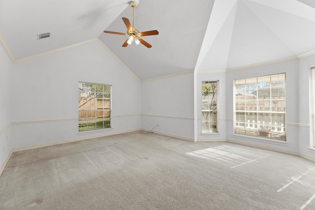 carpeted spare room with crown molding, high vaulted ceiling, and ceiling fan