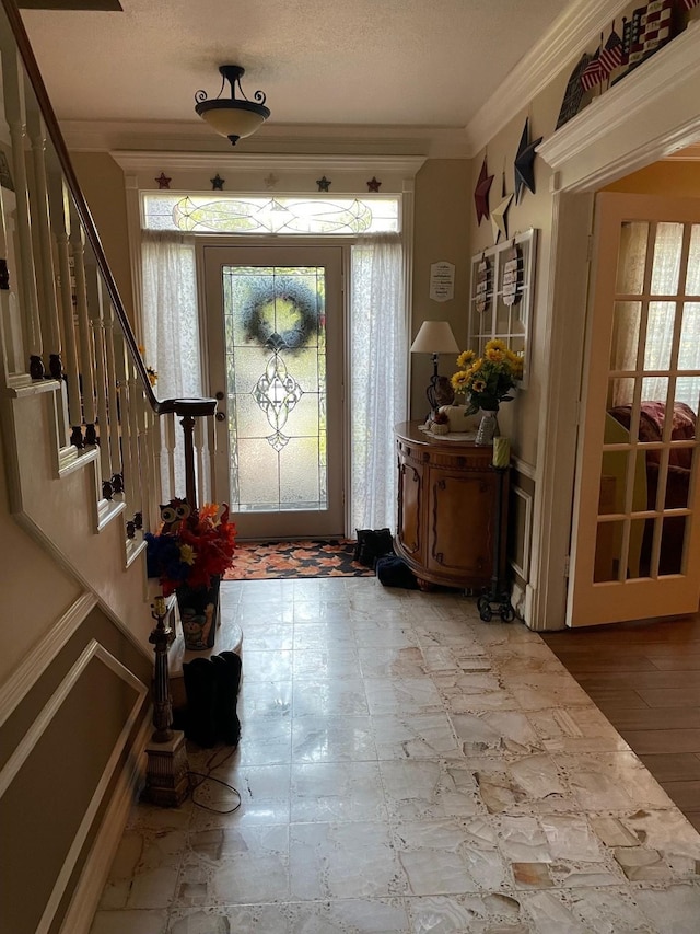 foyer entrance featuring ornamental molding