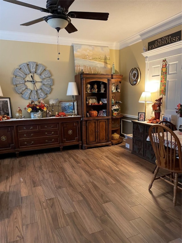 interior space featuring ornamental molding, hardwood / wood-style floors, and ceiling fan