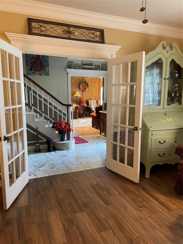 interior space with french doors, crown molding, hardwood / wood-style floors, and vaulted ceiling