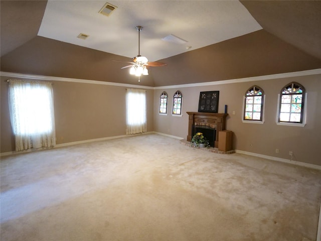 unfurnished living room with ceiling fan, ornamental molding, carpet flooring, and vaulted ceiling