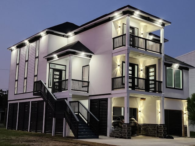 view of front of home with a garage and a balcony