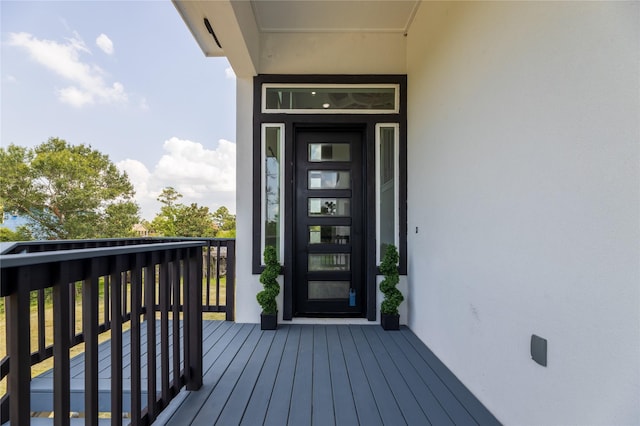 doorway to property featuring a balcony and stucco siding