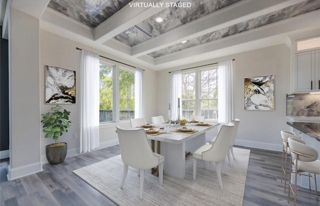 dining space featuring baseboards and wood finished floors