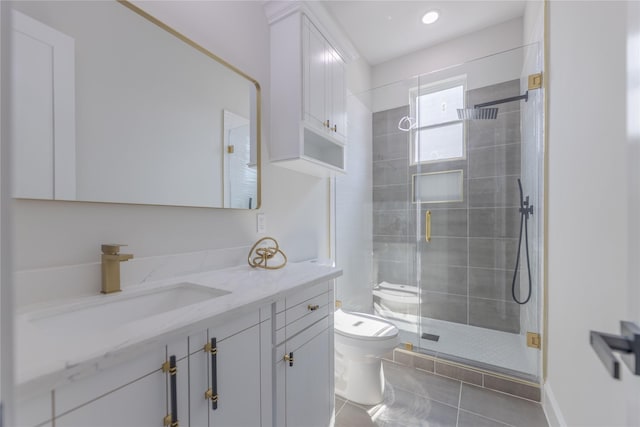 bathroom featuring toilet, a stall shower, tile patterned flooring, and vanity