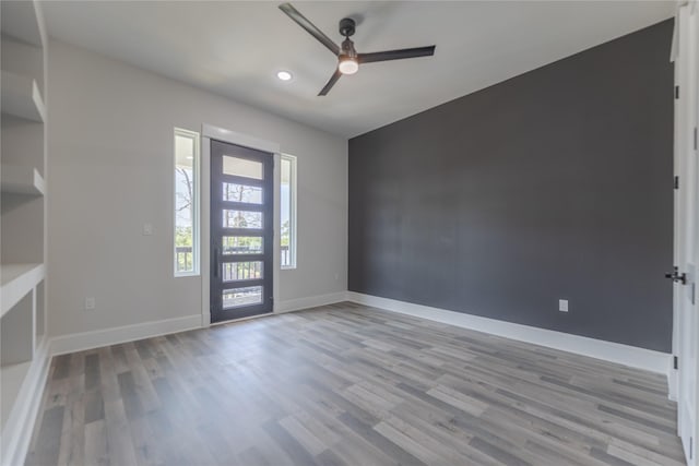 entrance foyer featuring ceiling fan, light wood-style flooring, and baseboards