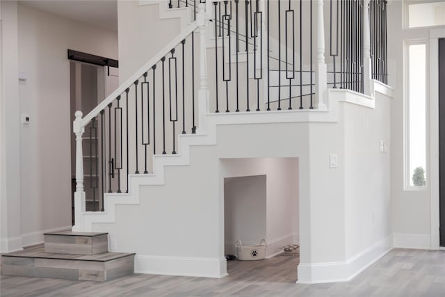 entrance foyer featuring stairway, baseboards, and wood finished floors