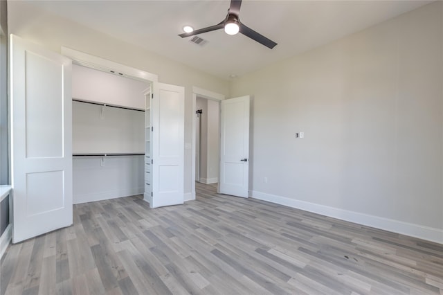 unfurnished bedroom with a closet, visible vents, a ceiling fan, light wood-type flooring, and baseboards