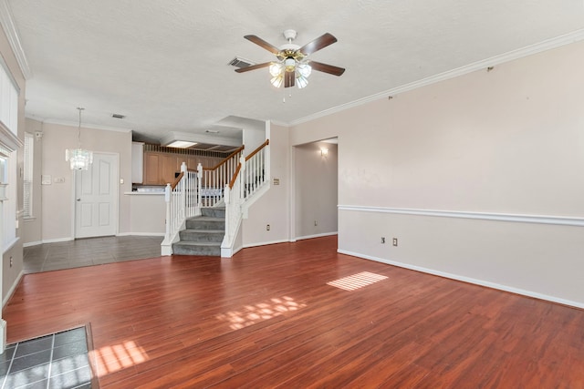 unfurnished living room with dark hardwood / wood-style flooring, ceiling fan with notable chandelier, ornamental molding, and a textured ceiling