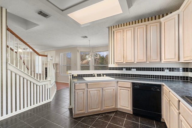 kitchen with dishwasher, sink, dark tile patterned flooring, hanging light fixtures, and kitchen peninsula