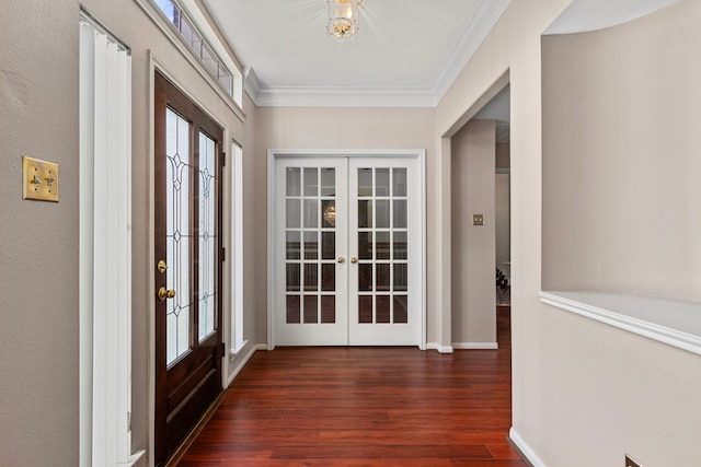 doorway with ornamental molding, dark hardwood / wood-style floors, a healthy amount of sunlight, and french doors