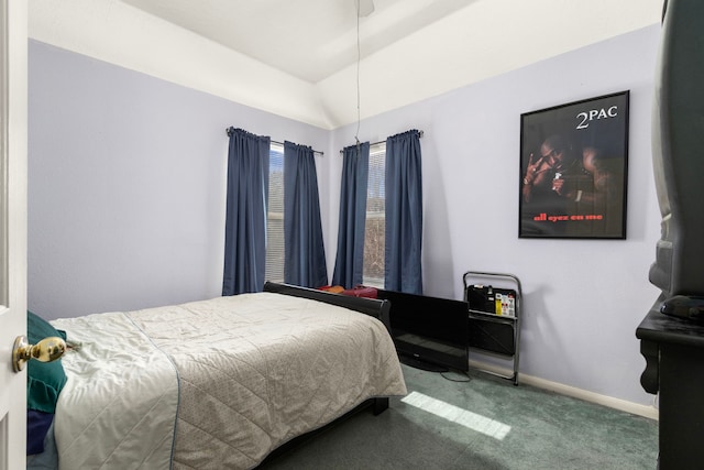 carpeted bedroom with lofted ceiling