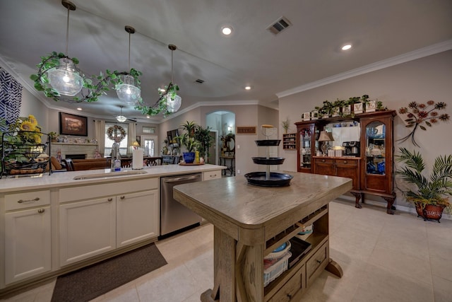 kitchen with sink, decorative light fixtures, a center island, ornamental molding, and dishwasher