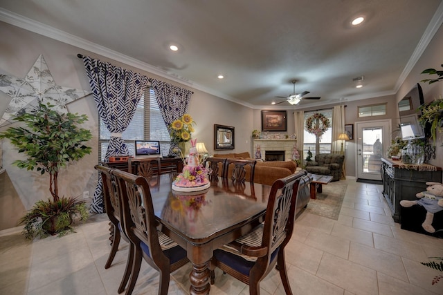 tiled dining area featuring crown molding and ceiling fan